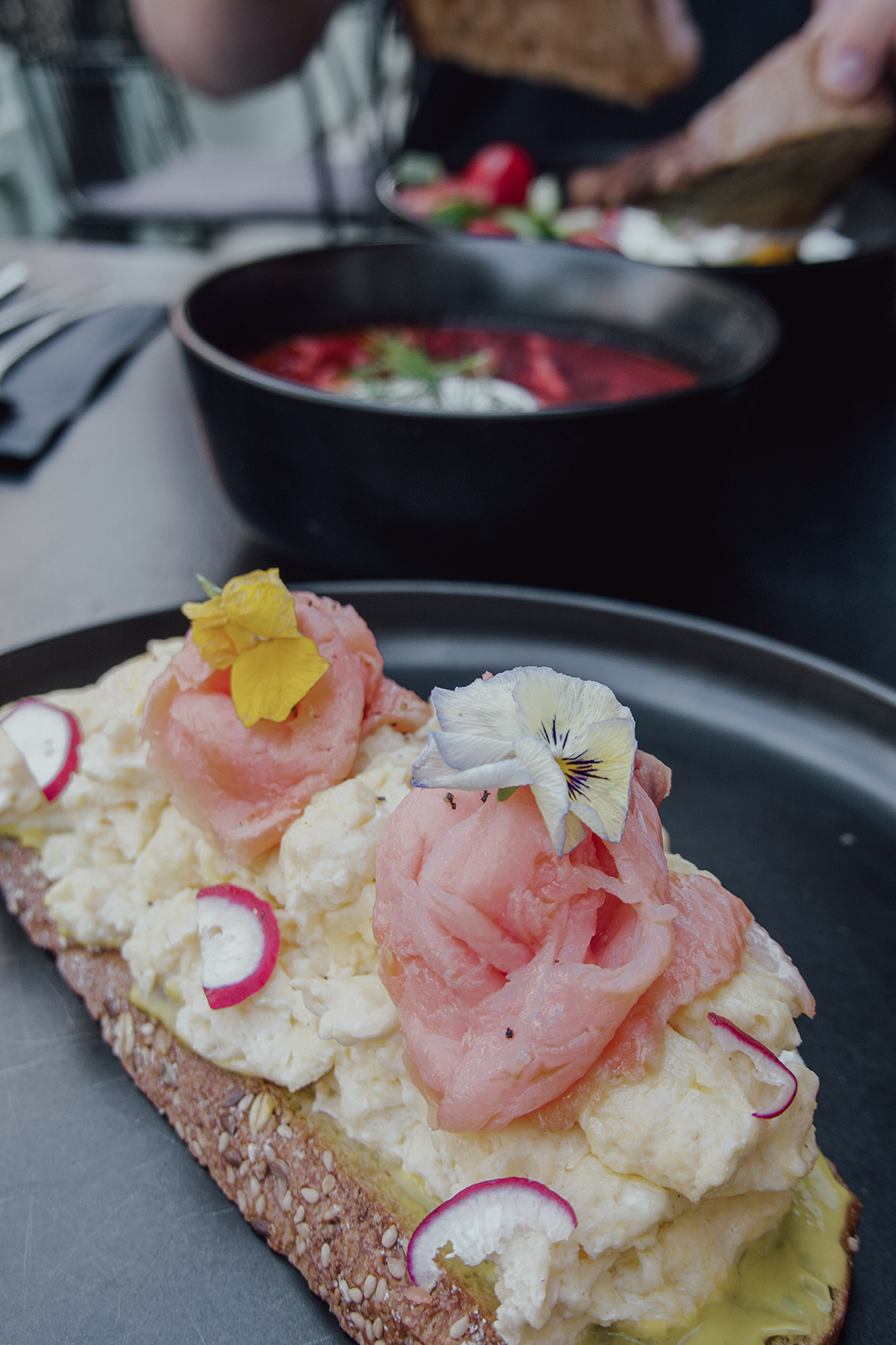 Breakfast with salmon and edible flowers